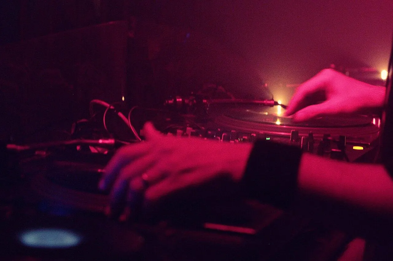 DJ mixing vinyl records in a London club